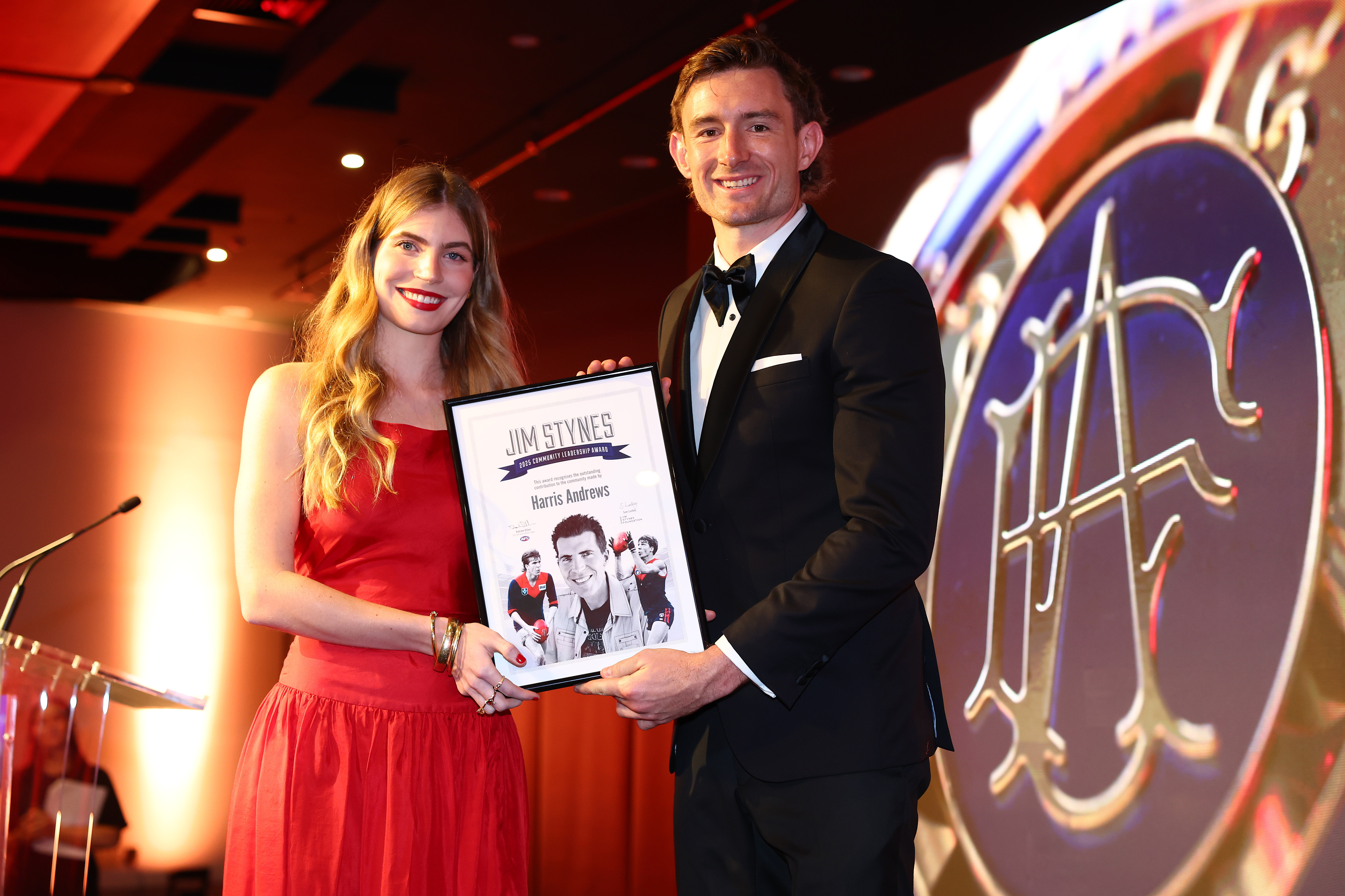 Harris Andrews of the Lions with poses with Matisse Stynes after receiving the Jim Stynes Community Leadership Award at the 2025 Brownlow Medal